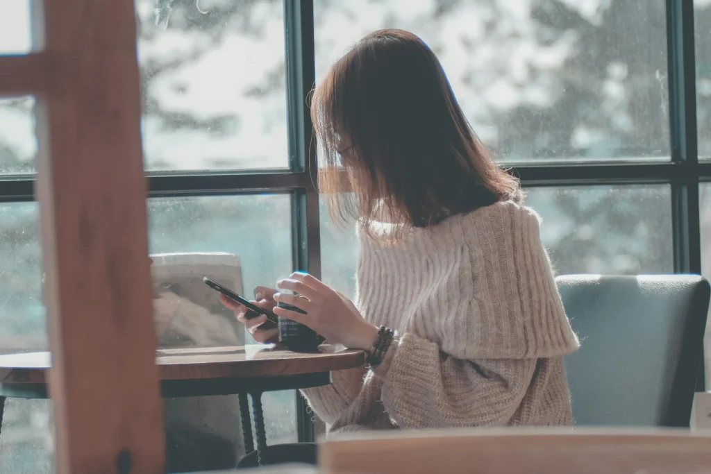 Person writing a thoughtful message on a smartphone for serious online dating communication