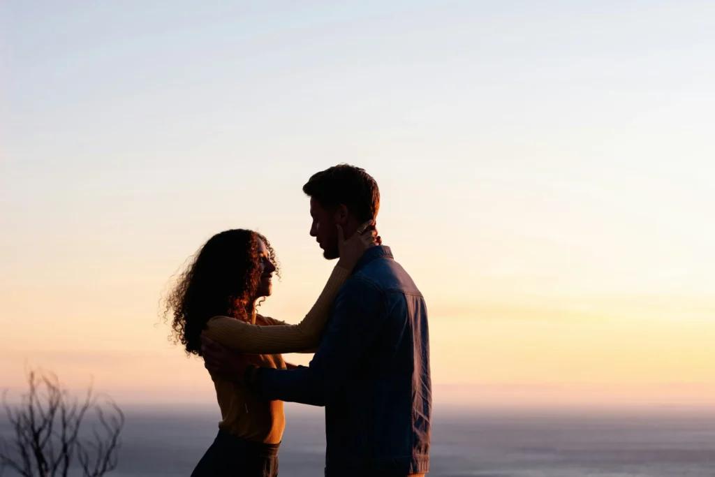 Adult couple embracing at sunset for a dating over 40 guide.